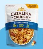 A package of Catalina Crunch Creamy Ranch protein snack mix featuring various snack items such as almonds, cashews, and pretzels against a white and blue background.
