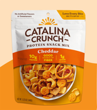 Packaging of Catalina Crunch Protein Crunch Snack Mix in Cheddar flavor, displaying the product and its features such as '10g protein', '1g sugar', and 'Good source of fiber'.
