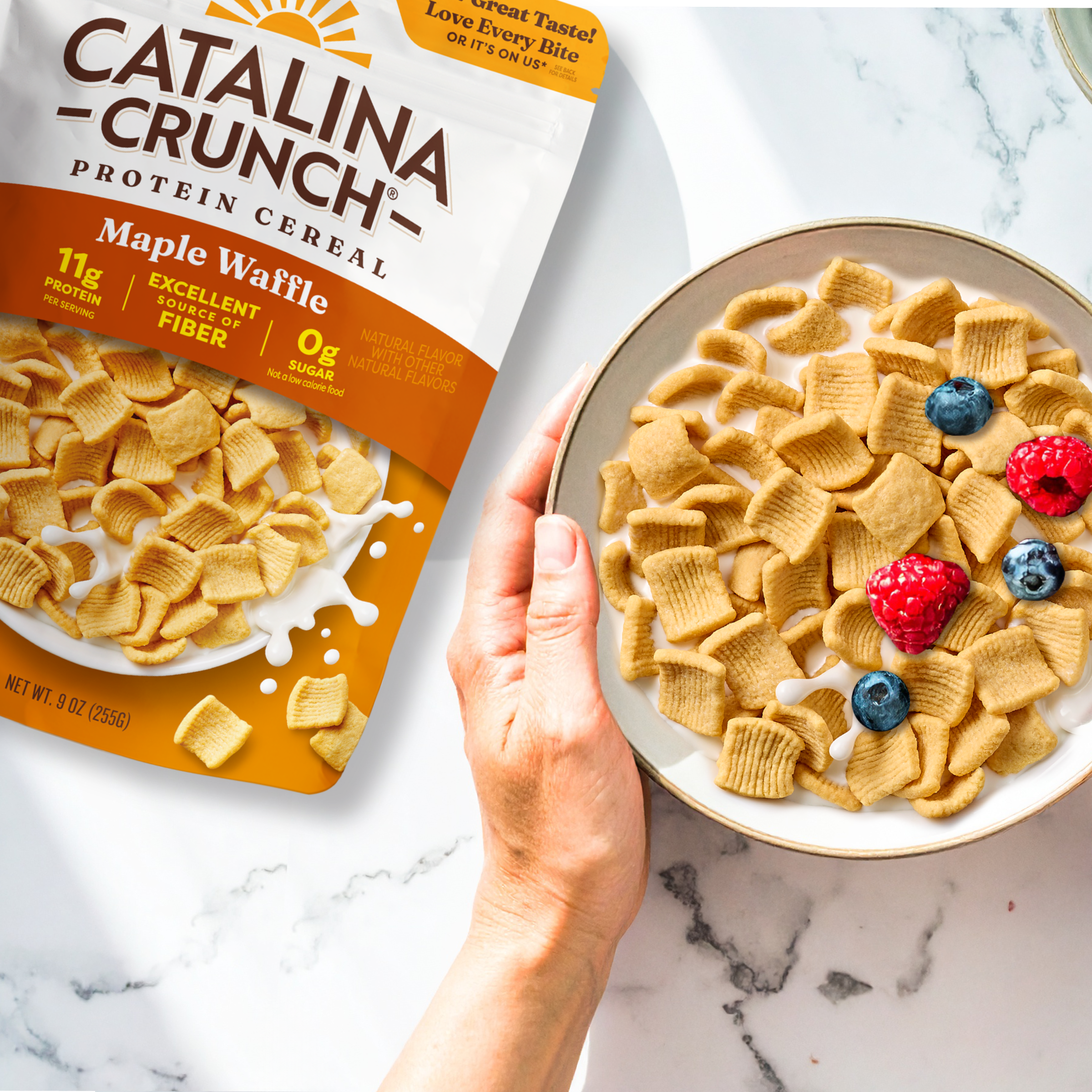 Catalina Crunch Protein Cereal package with a bowl of cereal on a marble surface