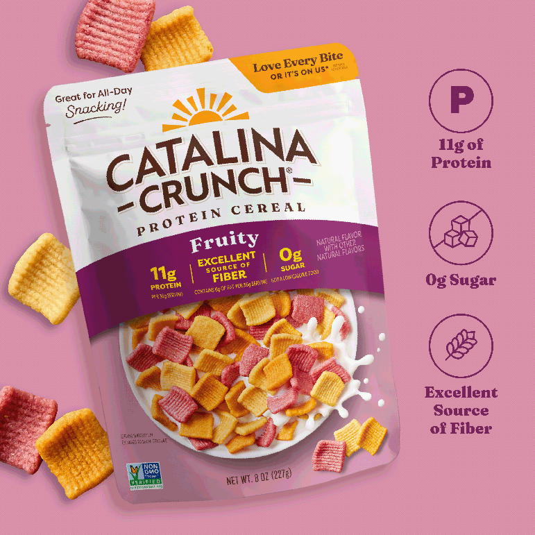 Catalina Crunch Protein Cereal package on a pink background with cereal pieces around.