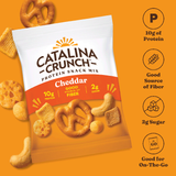 Catalina Crunch protein snack mix package on an orange background with snack items around.