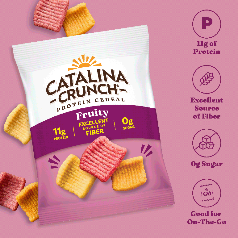 Catalina Crunch Protein Cereal package on a pink background with cereal pieces around