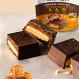 Catalina Crunch chocolate cookie bar with sea salt caramel filling on a light surface, with a package in the background.