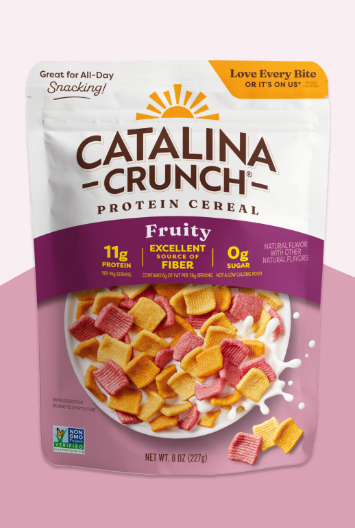 Catalina Crunch Protein Cereal package on a pink background